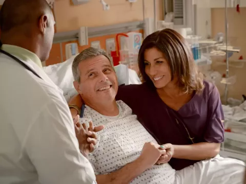 man-smiling-at-doctor-with-wife