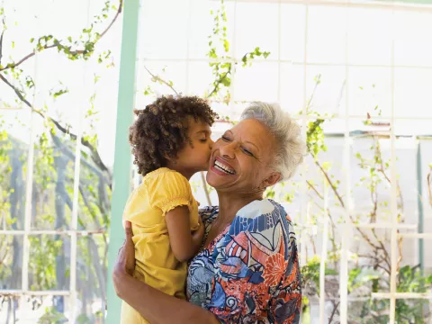 a-grandaughter-kisses-and-hugs-her-grandma
