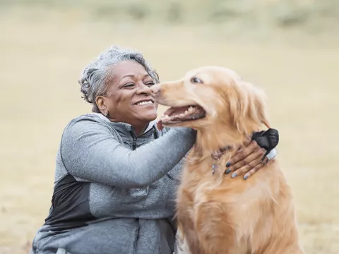 woman-hugging-her-dog outdoors
