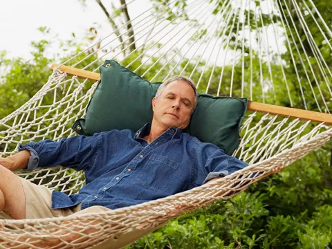 man-resting-in-a-hammock