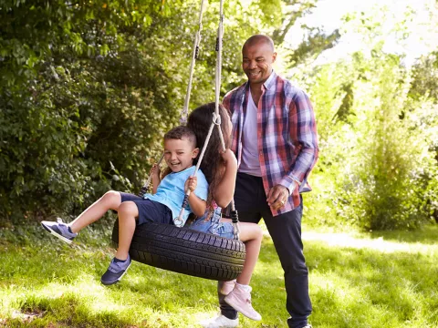 father-and-children-playing-outdoors