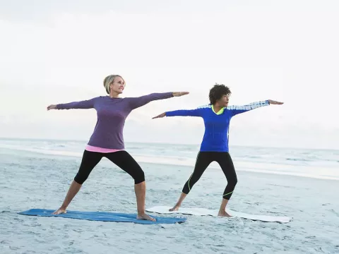 two-women-exercising-at-the-beach