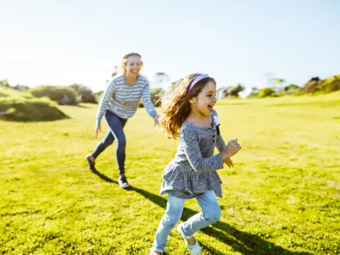 mother and daughter playing outdoors