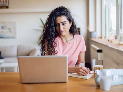 young-woman-taking-notes-pensive