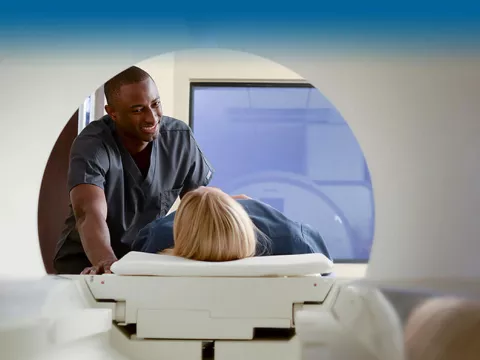 patient-entering-an-mri-machine and talking to technician