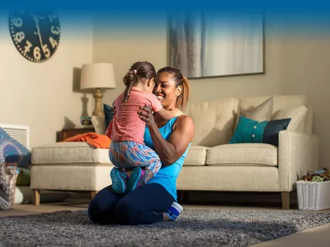 Woman with child on living room floor