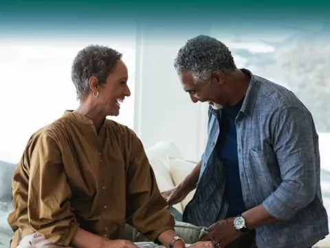 couple laughing next to each other indoors