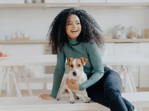 woman seating with her dog