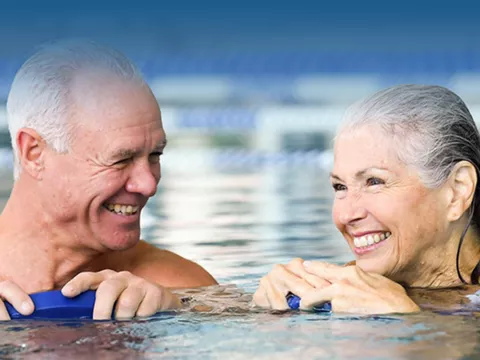 lp-hero-desktop-rothman-general-bg-couple-in-pool-gradient.jpg