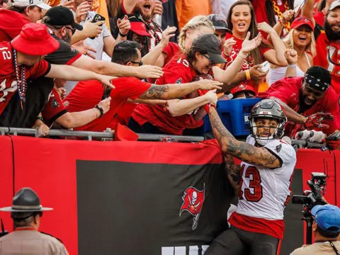 bucs player jumping into crowd