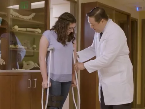 A Doctor Helps a Patient Adjust Her New Crutches