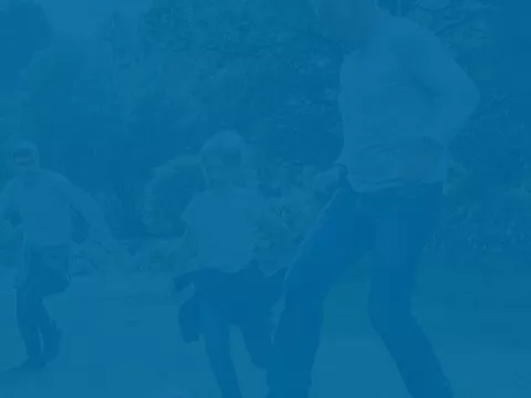 Family playing sports in a backyard, the image tinted blue