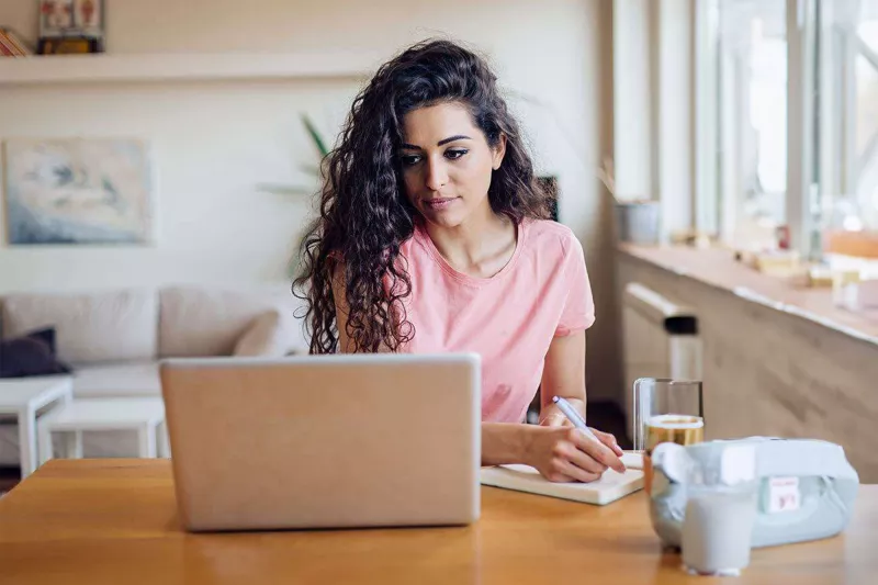 young-woman-taking-notes-pensive