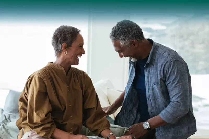 couple laughing next to each other indoors