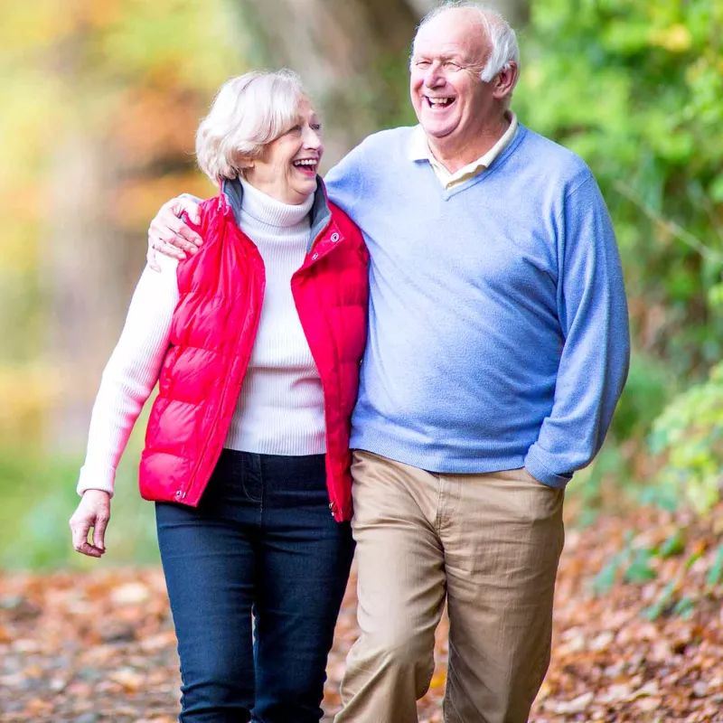 A happy older couple walking outdoors.