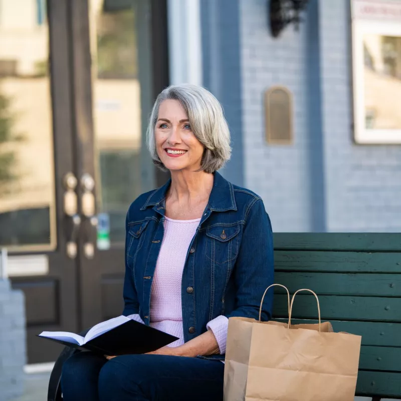 a woman sitting on a bench