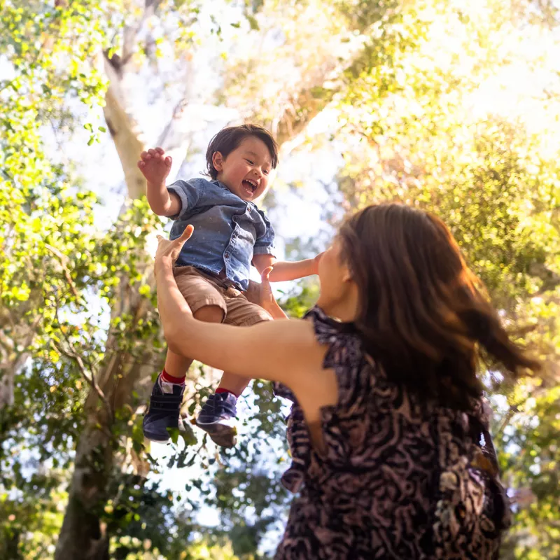 mother-playing-with-her-infant-son-outdoors