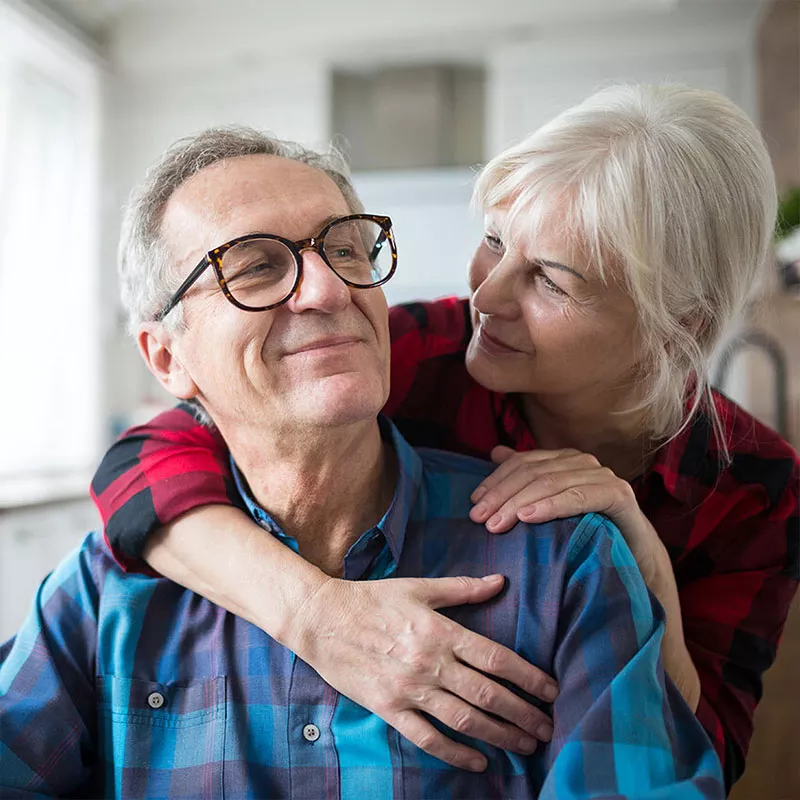 an-older-couple-hugging-and-smiling