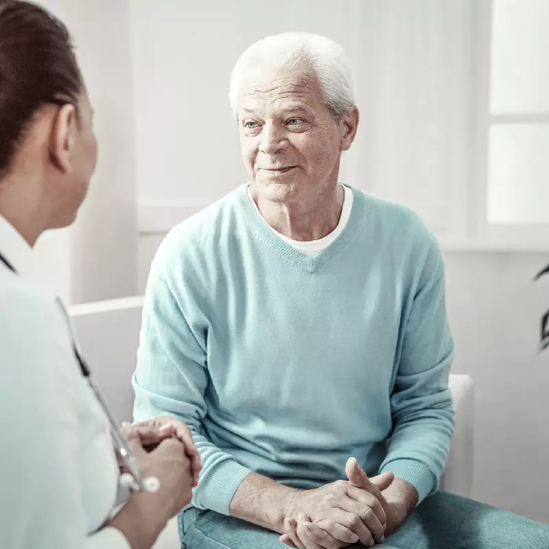 Older man talking to doctor
