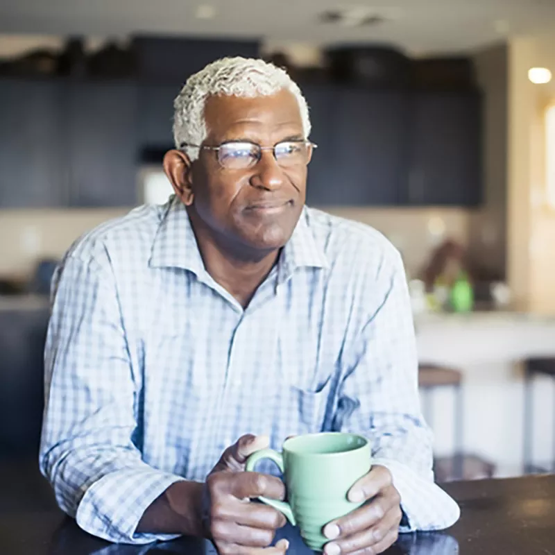 older-man-drinks-coffee and looks pensive