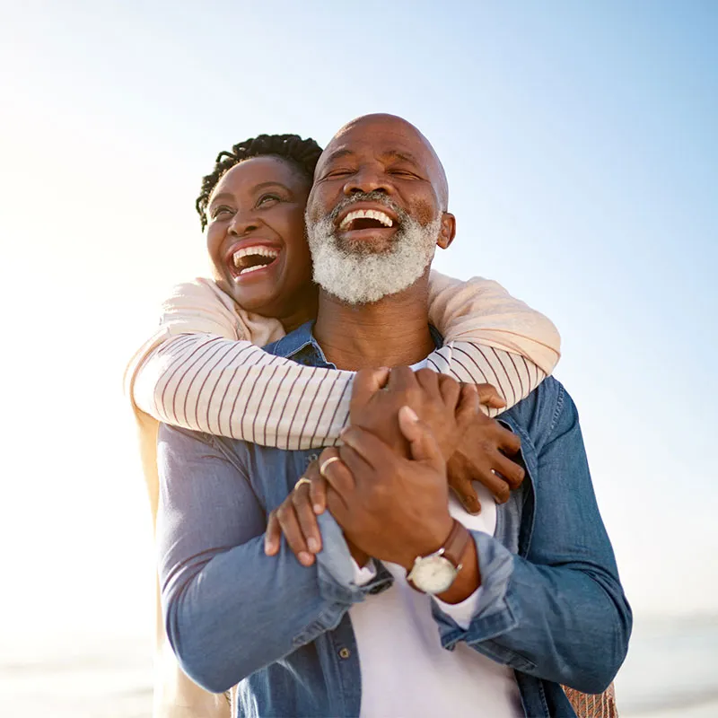 couple outdoors hugging and laughing