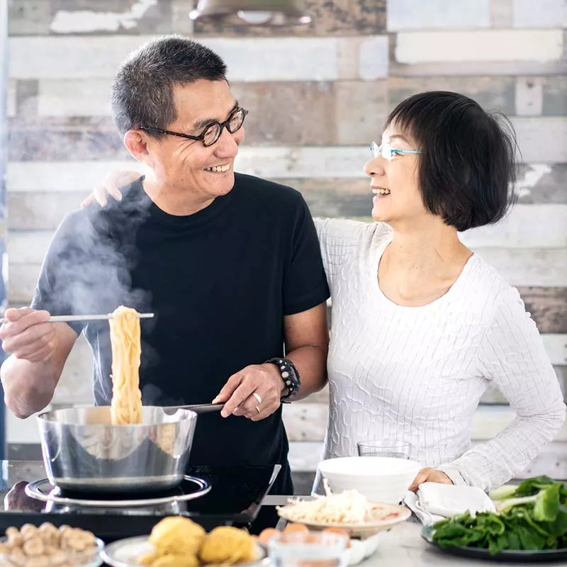 Asian couple cooking together