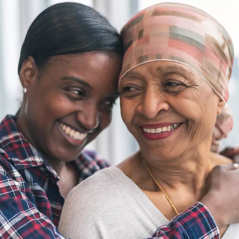 Mother and adult daughter embracing