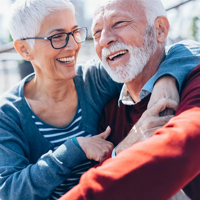 Older man and woman embracing