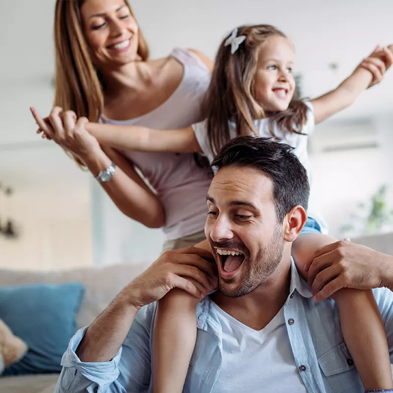 Family mom dad daughter Playing on couch Inside Home