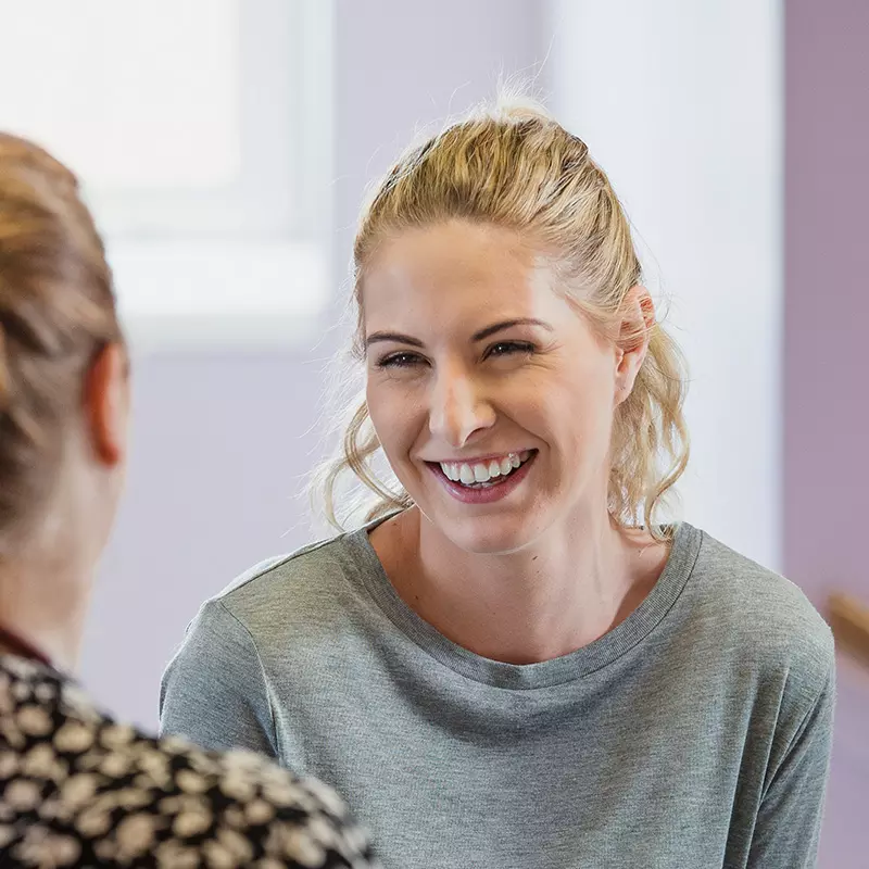 Two Women Laughing Indoors