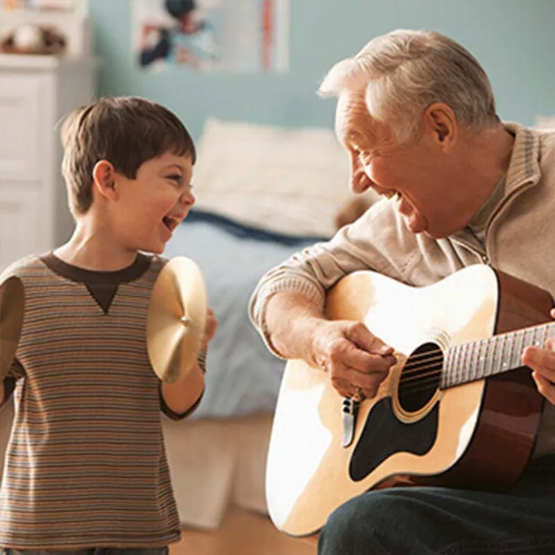 Grandfather and grandson playing music together