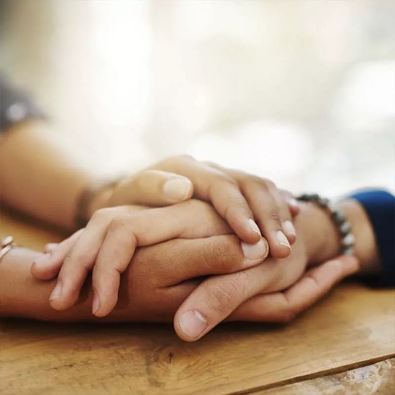 Holding hands on table