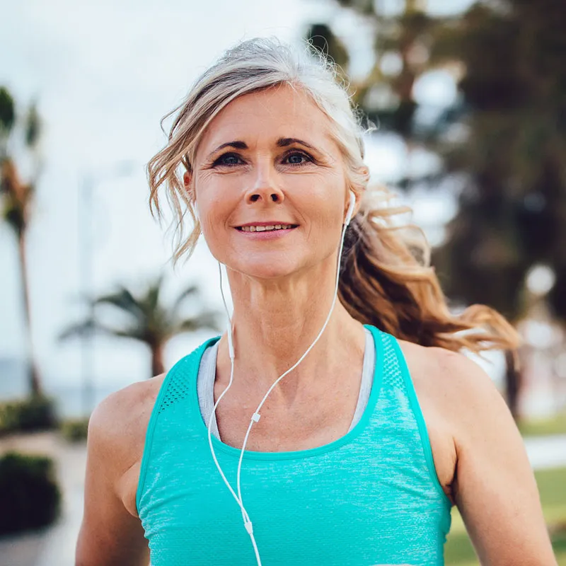 woman jogging wearing earphones