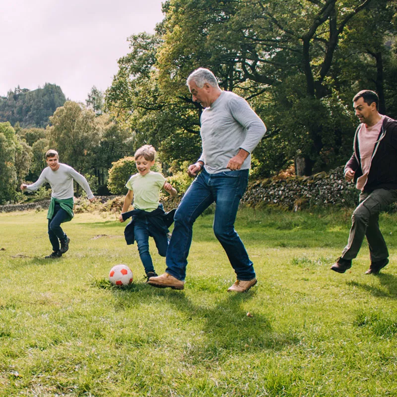 family-playing-soccer-outdoors