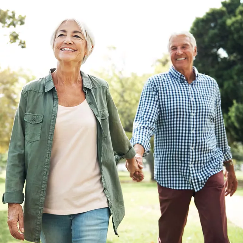 older-couple-holding-hands-outdoors