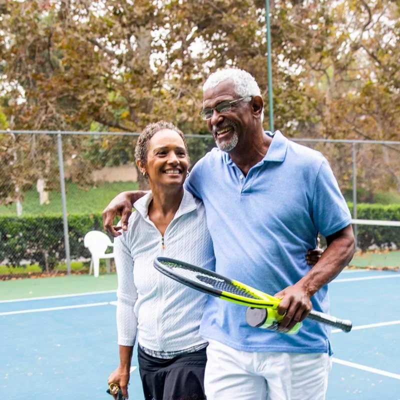 Older couple playing tennis