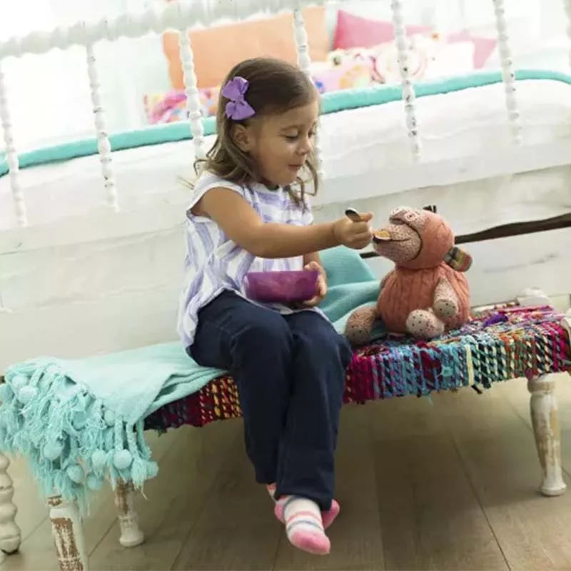 Girl feeding toy monkey