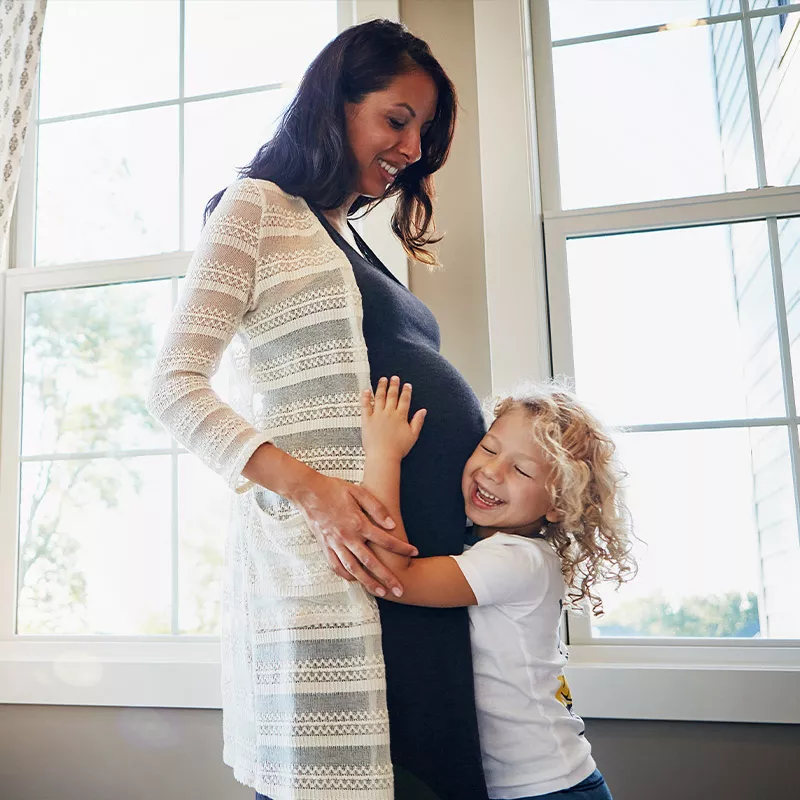 daughter-hugs-her-mothers-pregnat-belly