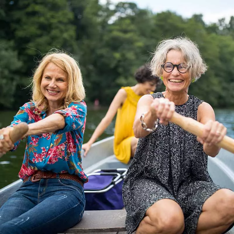 Middle-aged women rowing boat