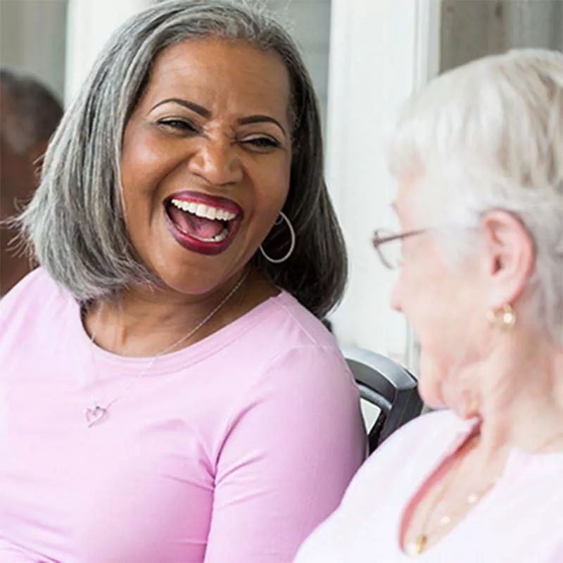 Old black and white women laughing