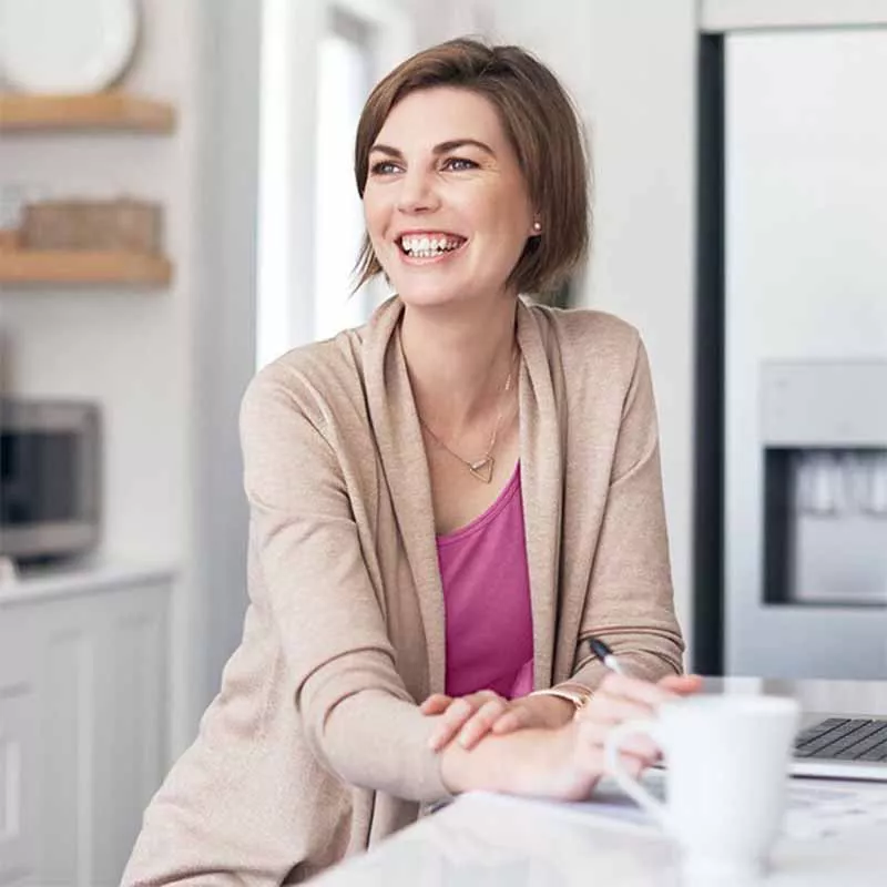 Woman on computer in kitchen