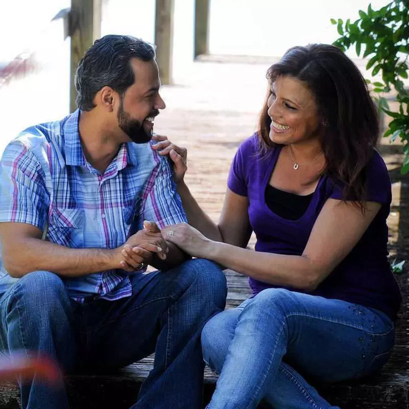 couple seating and conversing outdoors