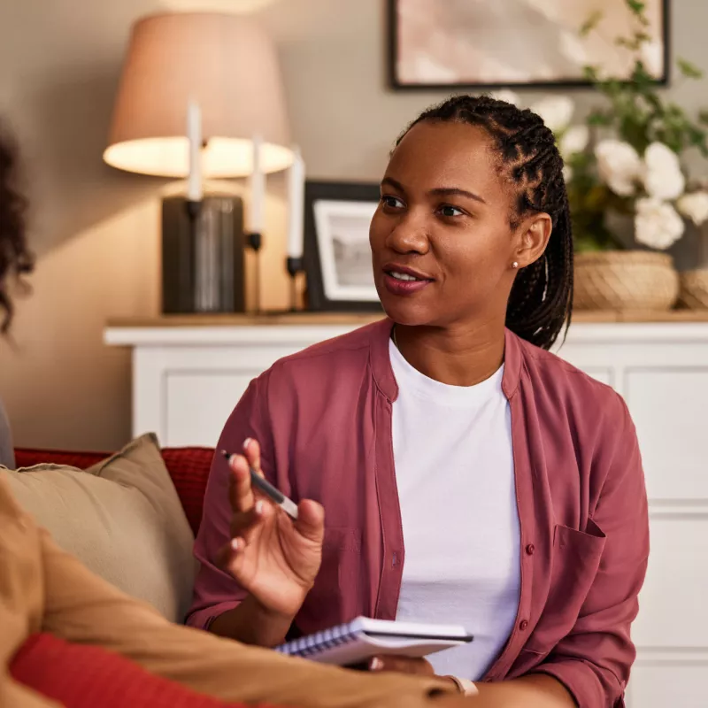 Mental health provider speaking to young client.