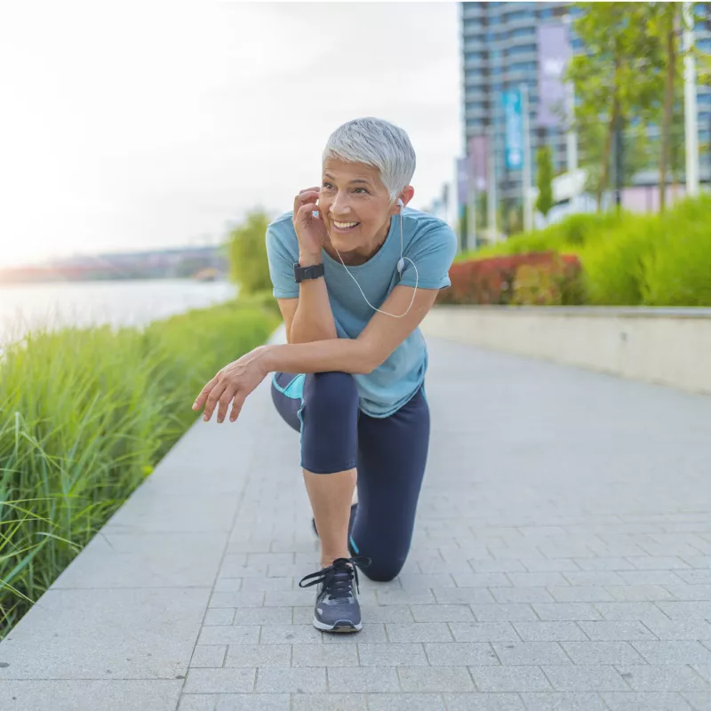 Older female runner taking a break