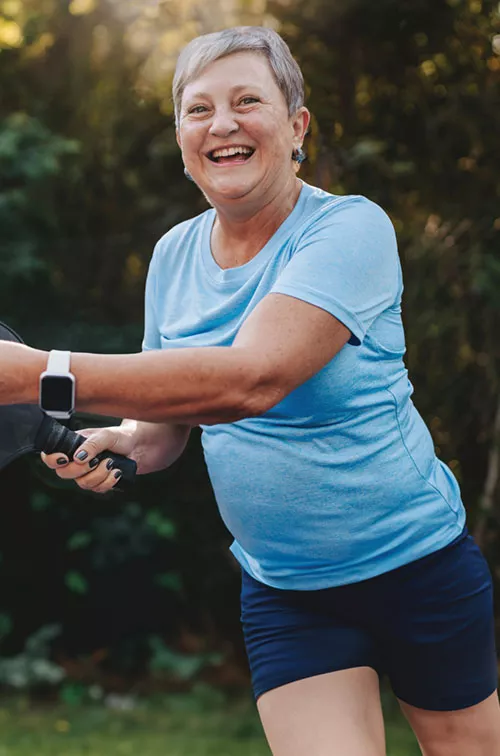 Woman playing pickleball outdoors