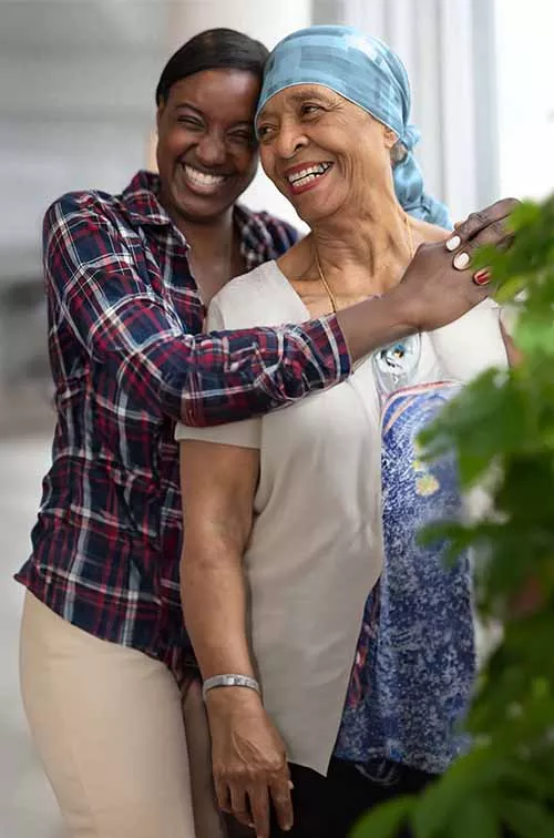 Cancer mom and daughter hugging