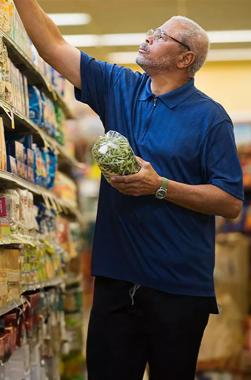 Man at the supermarket shopping for food