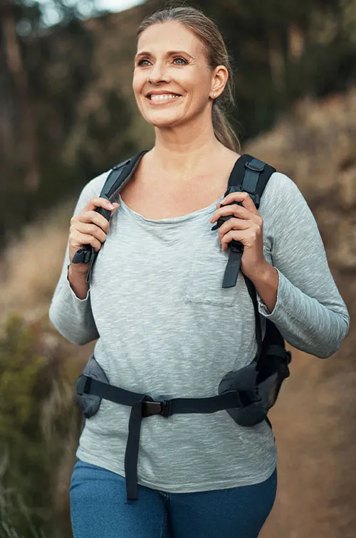 woman hiking and smiling