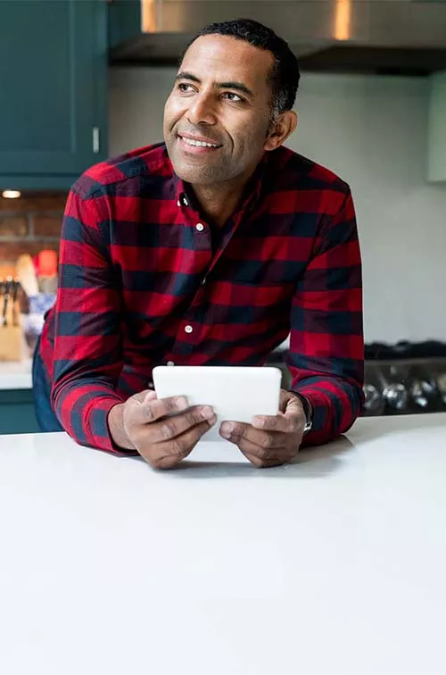 Man in kitchen with tablet