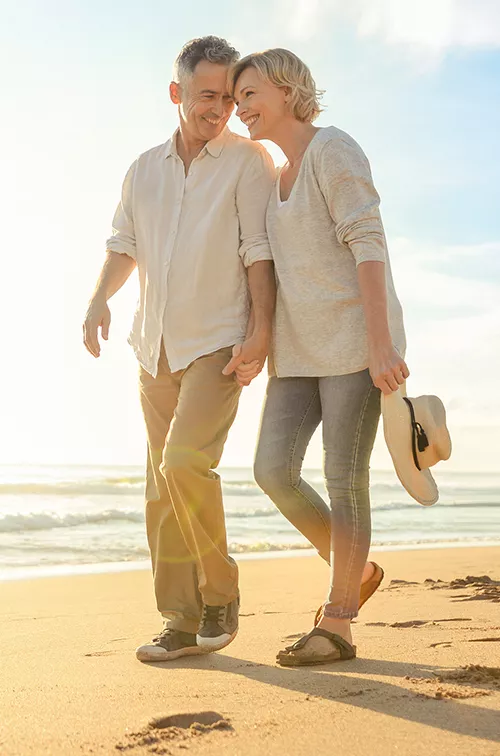 lp-hero-desktop-west-fl-general-surgery-couple-walking-at-the-beach